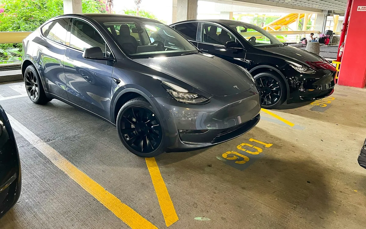 Gray Tesla Model Y parked in a parking garage